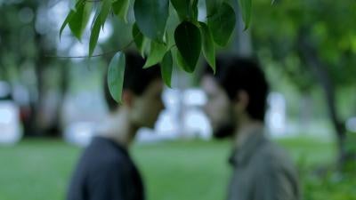 Two men talking in park