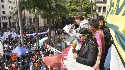 Indigenous leaders read a manifesto to a large crowd at a law school