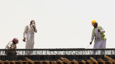 Migrant workers at a construction site amid scorching heat