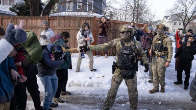 A US Border Patrol Tactical Unit agent sprays pepper spray into the face of a protestor near the scene where a woman was shot and killed by a federal agent, in Minneapolis, Minnesota, January 7, 2026.
