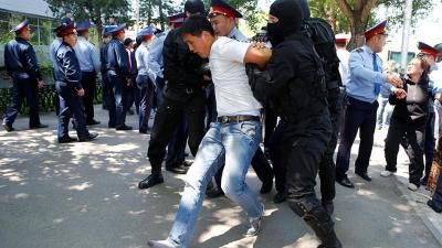 Police arrest protester in Kazakhstan. 