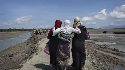 Rohingya women refugees who crossed the Naf River from Burma into Bangladesh continue inland toward refugee camps.