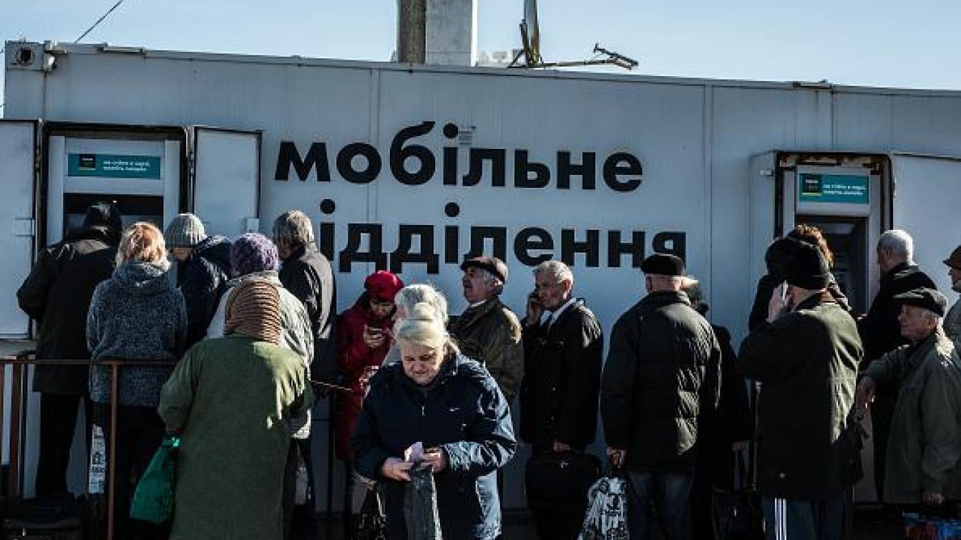 Older people lining up at bank machines in government-controlled areas of Ukraine.