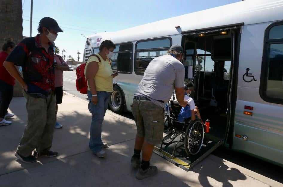 Patrons get on an express bus set up by the city Phoenix, Arizona, to take people to a heat relief station inside the Phoenix Convention Center, May 29, 2020.