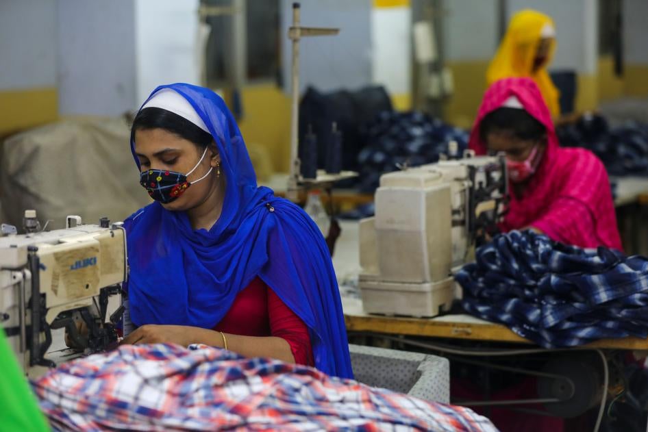 Workers sew clothes in a garments factory in Dhaka, Bangladesh, July 25, 2020.