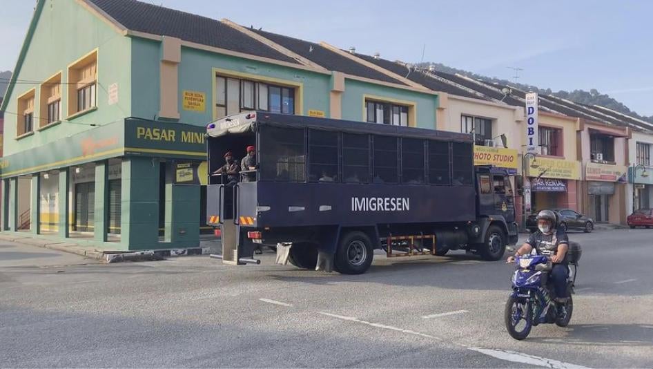 Image taken from a video of an immigration truck with security guards and unidentified people on the road to Lumut Naval Base on Tuesday, February 23, 2021 in Lumut, Malaysia. 