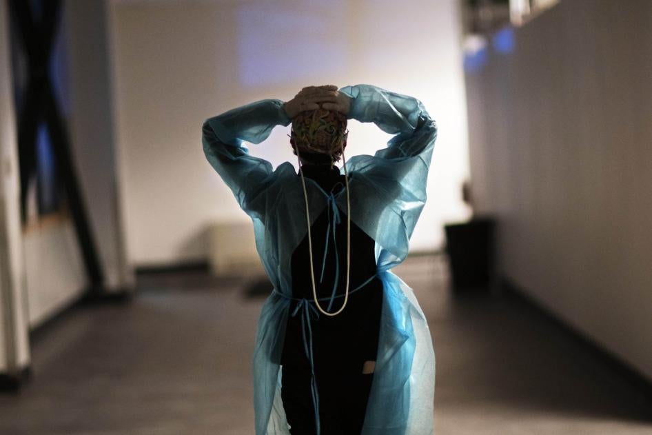 Registered traveling nurse Patricia Carrete walks down a hallway during a night shift at a field hospital set up to handle a surge of COVID-19 patients, Wednesday, Feb. 10, 2021, in Cranston, Rhode Island, US.
