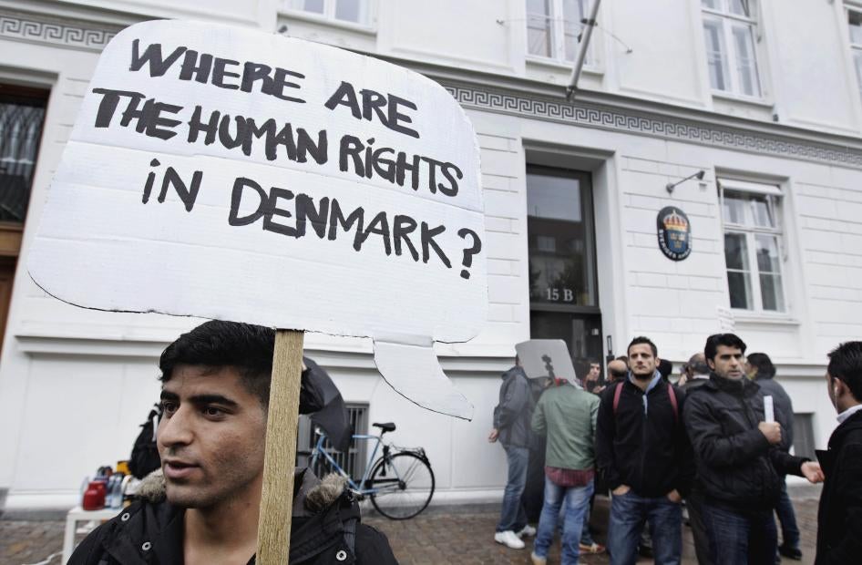 Syrian refugees hold banners outside the Swedish Embassy in Copenhagen, Denmark, protesting Denmark's asylum policies towards those who fled Syria's civil war, September 26, 2012.