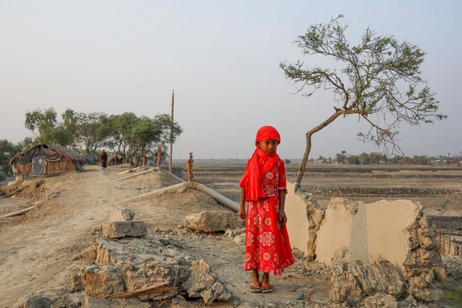 A girl surrounded by land devastated by Cyclone Amphan in Satkhira