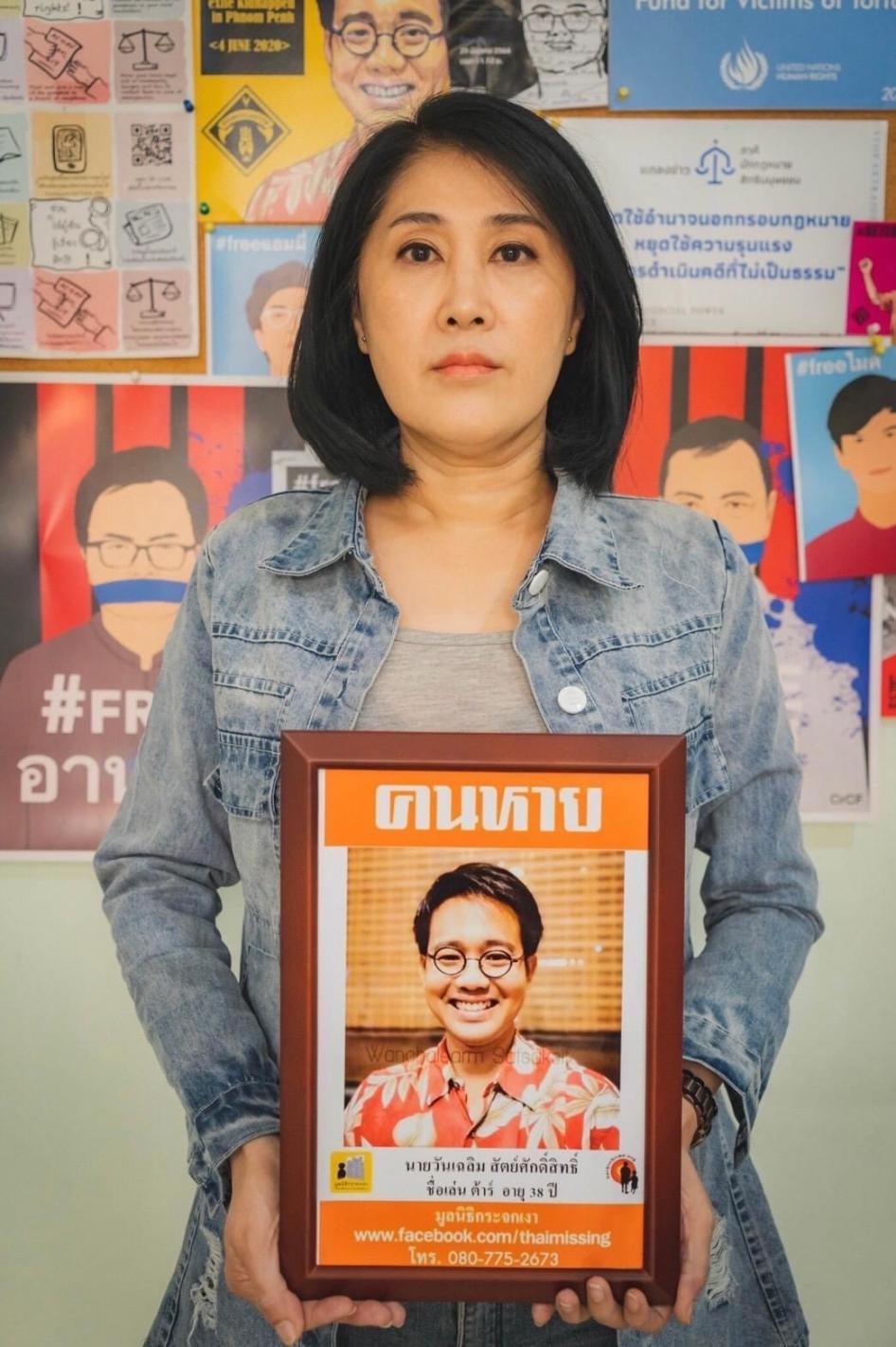Sitanun Satsaksit holds a portrait of her brother, Wanchalearm, who was forcibly disappeared while living in exile in Cambodia on June 4, 2020. 