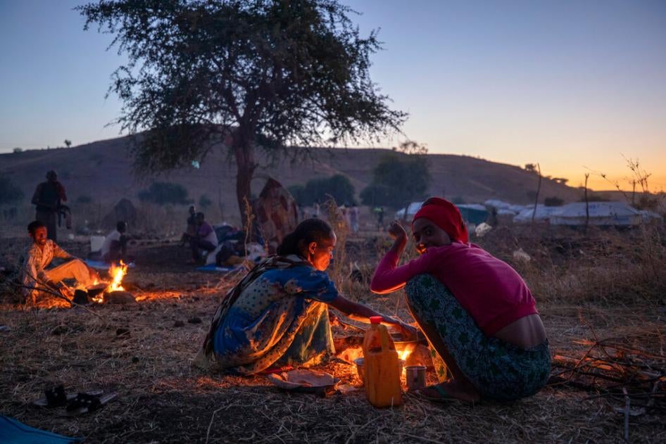 Tigrinyan refugee women prepare bread for their family in Umm Rakouba refugee camp in Qadarif, eastern Sudan on December 11, 2020 