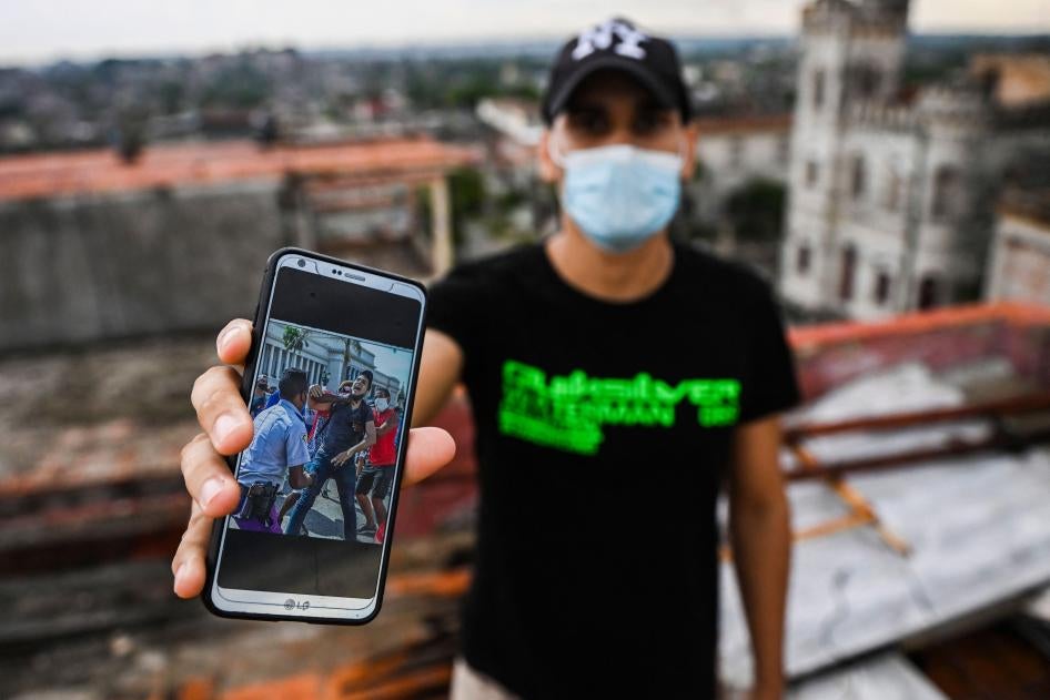 Cuban Rolando Remedios shows a photo of him being arrested during the July 11 protests on his mobile phone at his home in Havana, Cuba, on August 7, 2021.