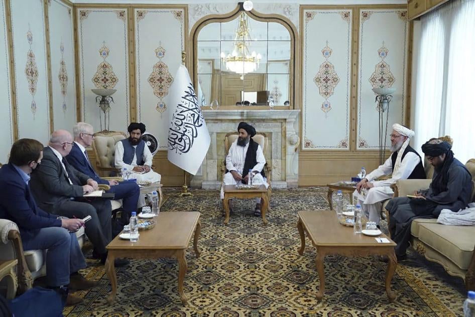 Taliban Deputy Prime Minister Mullah Abdul Ghani Baradar, center, meets with Sir Simon Gass, the British prime minister's high representative for Afghan transition, left, at the presidential palace in Kabul, Afghanistan, October 5, 2021.