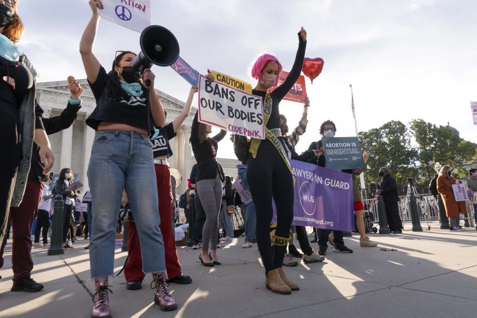 Women holding protest signs