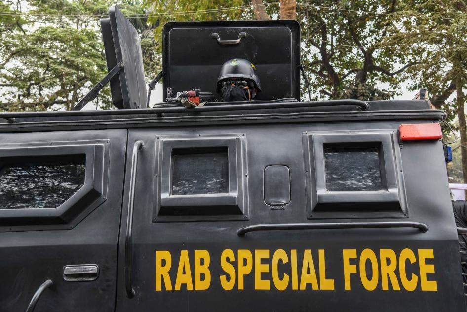 A Bangladeshi RAB (Rapid Action Battalion) member stands alert inside a truck at the Central Shaheed Minar in Dhaka, Bangladesh, February 20, 2021.
