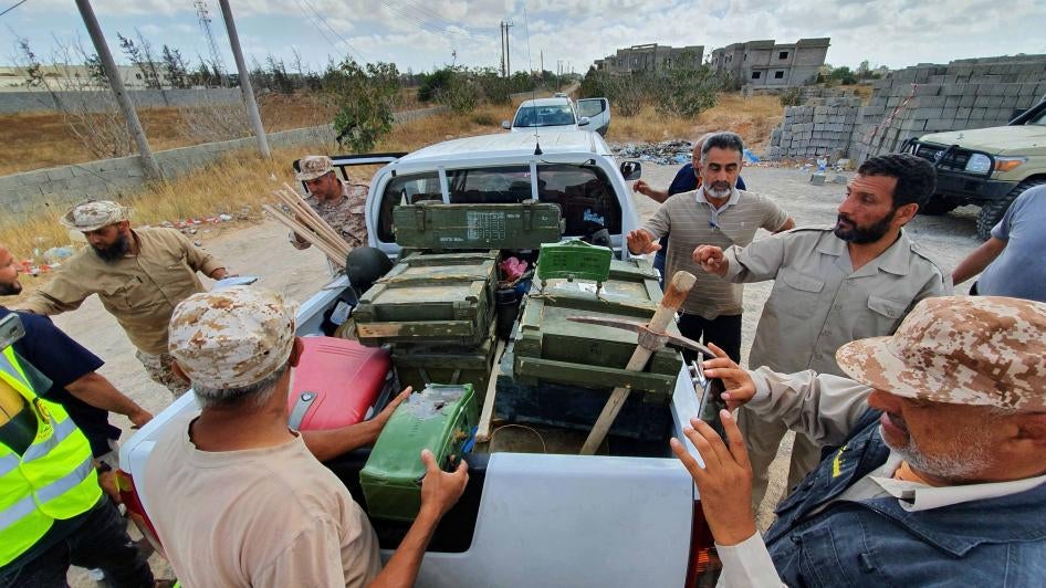 Libyan deminers stand around a pickup truck with boxes of dismantled mines and remnants of other explosives in Salah al-Din, south of the Libyan capital, Tripoli, June 15, 2020.&nbsp;​​​​​​​