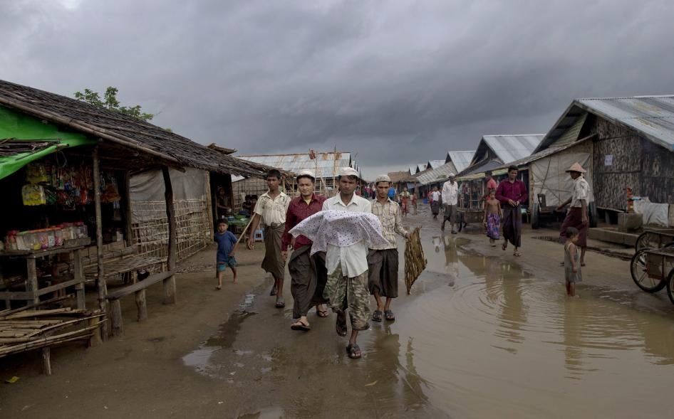 A Rohingya man carries the body of his niece