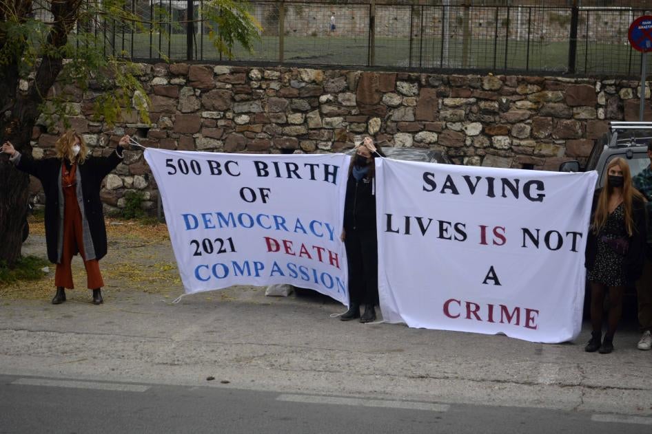 People hold banners outside a court