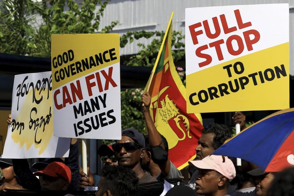 Sri Lankan anti-government protesters holding signs