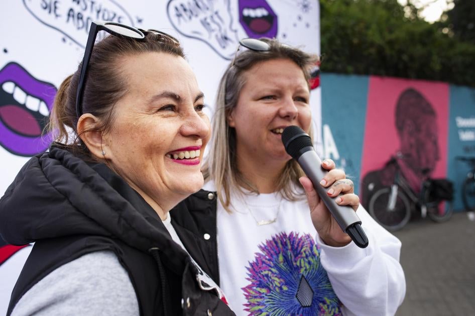Justyna Wydrzyńska (left) and a colleague from the group Abortion Dream Team address a gathering in Warsaw city center to share the experiences of people who needed abortions, September 28, 2021.