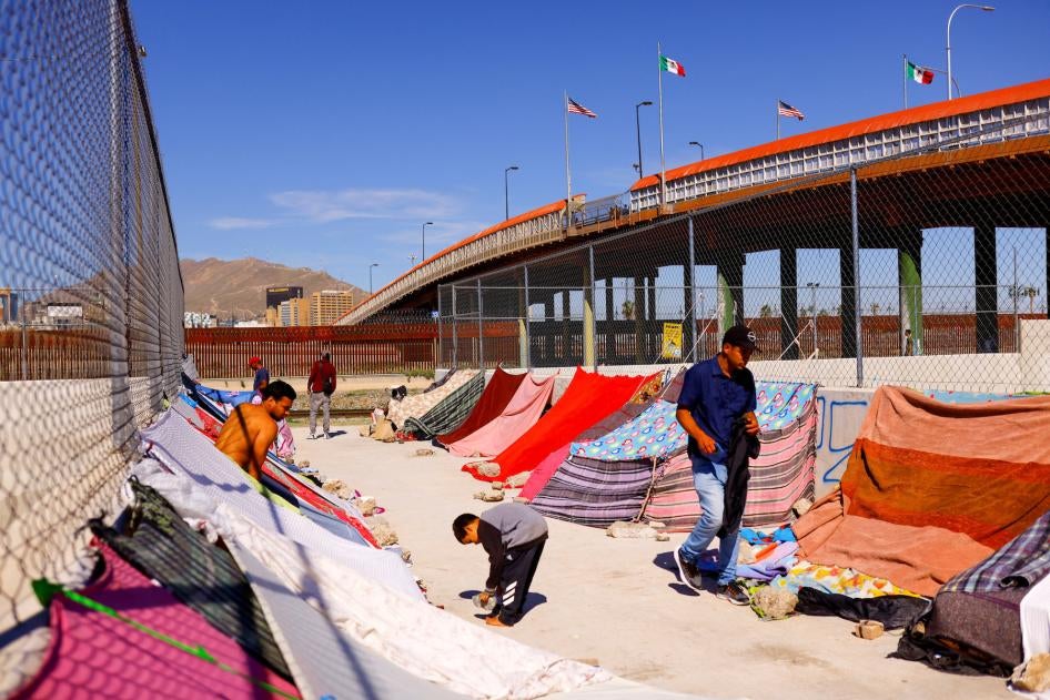 Venezuelan migrants stand near the Paso del Norte International Bridge, in Ciudad Juarez, Mexico.