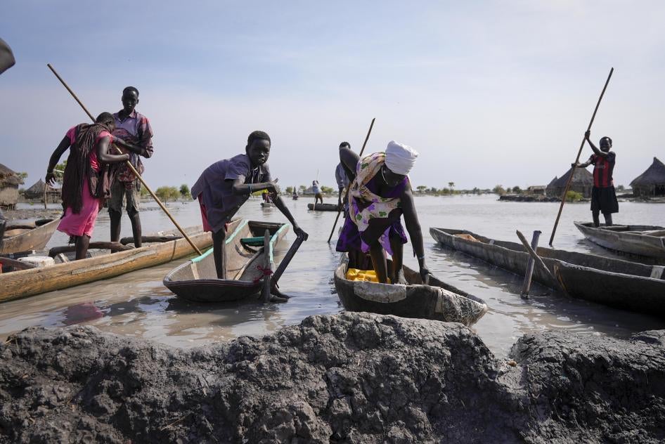 Residents park their dugout canoes next to a mud dyke they built to try and prevent flooding