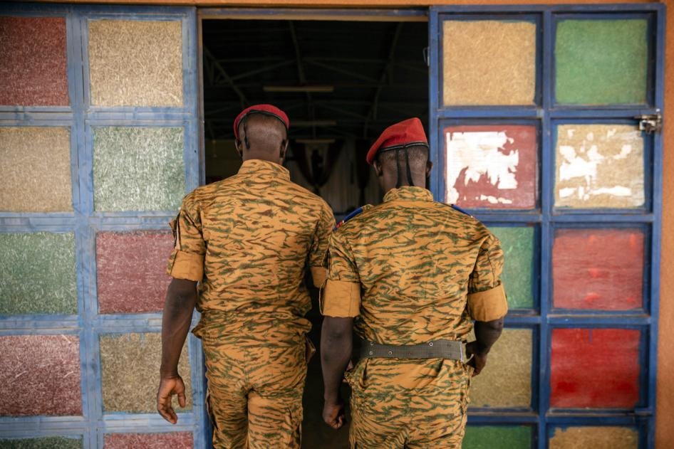 Two uniformed soldiers walk into a church