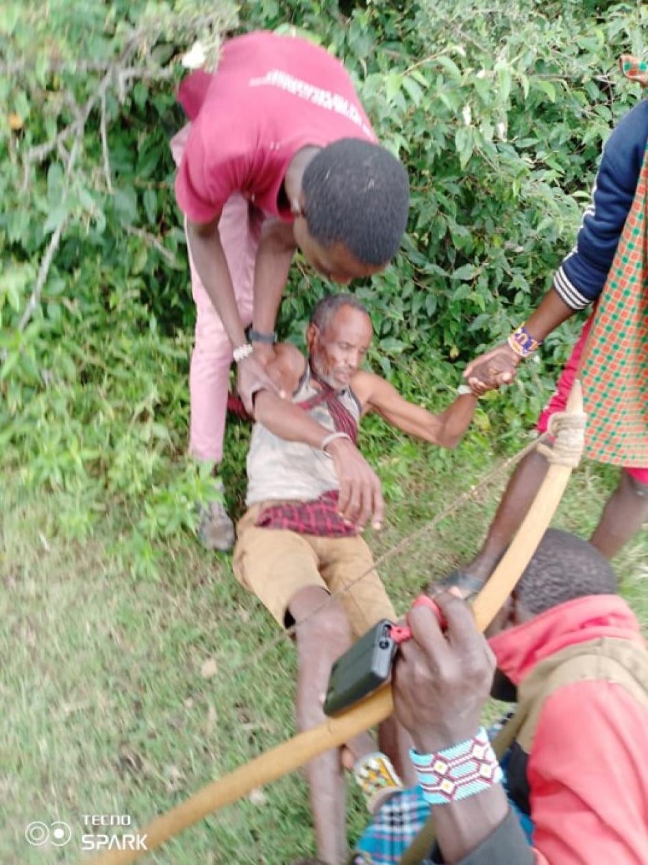 Tanzanian Maasai people helping an older Maasai man who had been beaten and injured by Tanzanian security forces after the outbreak of violence on June 10, 2022, in Loliondo, Arusha region, Tanzania. 