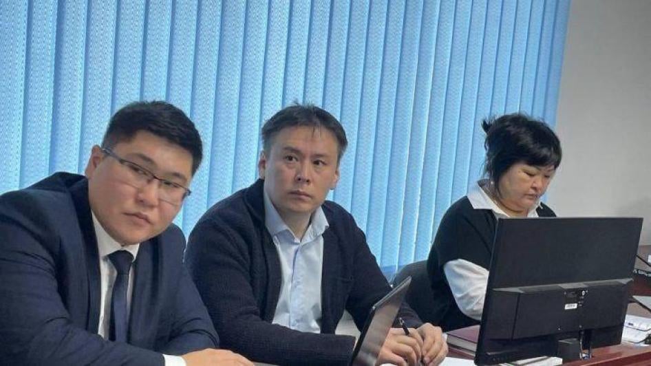 Zhanbolat Mamay, left/center, sits with his lawyers during a trial hearing in November 2022 in Almaty, Kazakhstan.