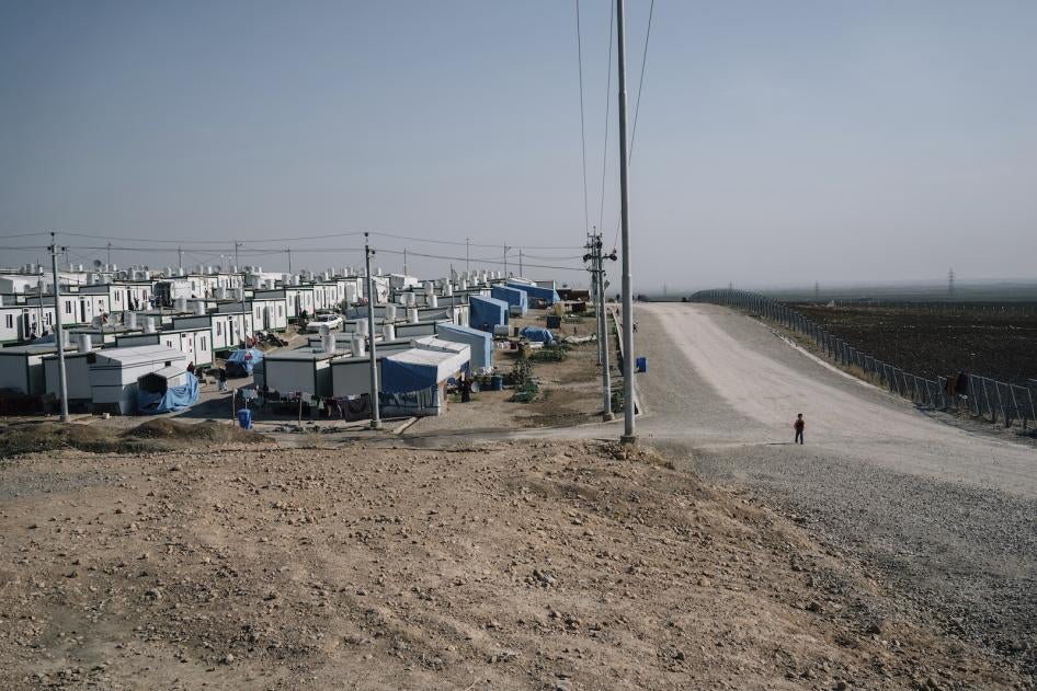 A boy walks on a road at the Mamrashan camp for civilians displaced by war, located a half hour's drive from Dohuk city in Iraq.