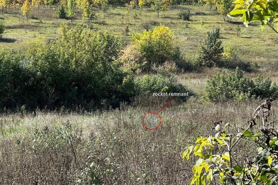 The carrier section of an 9M27K-series Uragan rocket lodged in the ground near a family’s home in Hlynske village, apparently fired from the west, where Ukrainian forces controlled territory while the area was under Russian occupation in 2022.  Each rocket delivers 30 9N210 or 9N235 submunitions.