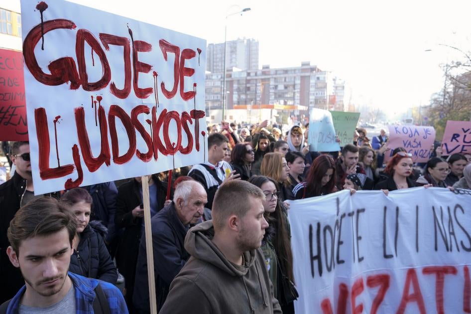 A man holds a banner that reads "Where is Humanity" during a protest following the release of disturbing photos from the Pazaric care home, Sarajevo, Bosnia, November 22, 2019. 