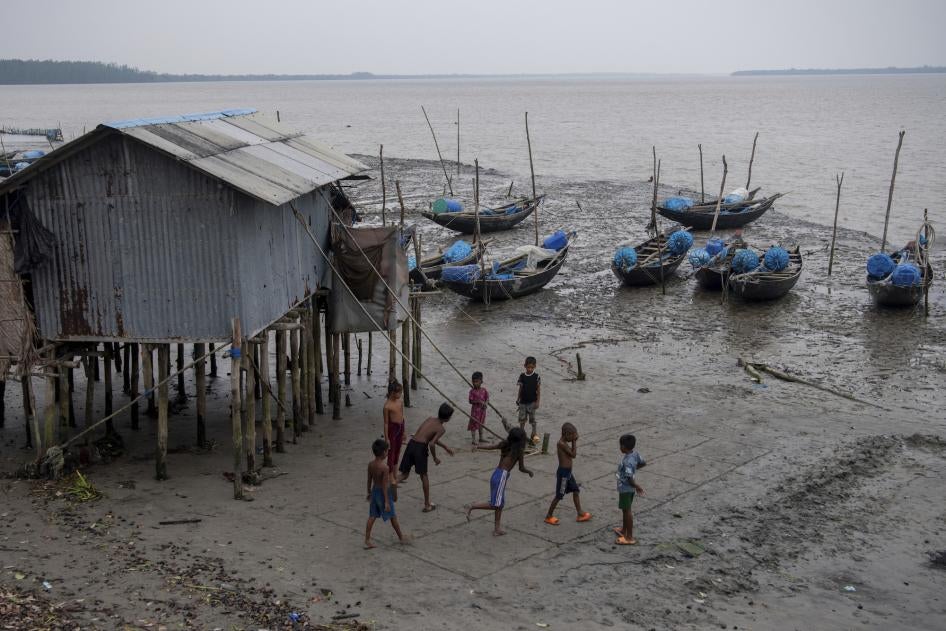 Children playing along the broken bank of the Shibsha River at Dakop Upazilla, Khulna, Bangladesh, August 26, 2023. 