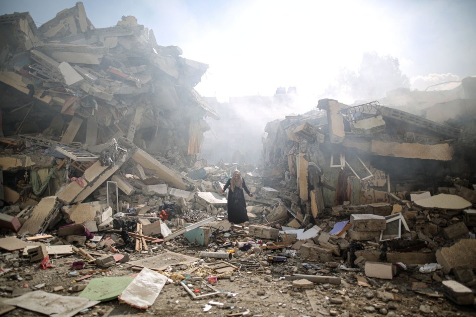 A resident walks amid the rubble of residential buildings after Israeli airstrikes in al-Zahra neighborhood in the Gaza Strip, October 19, 2023. 
