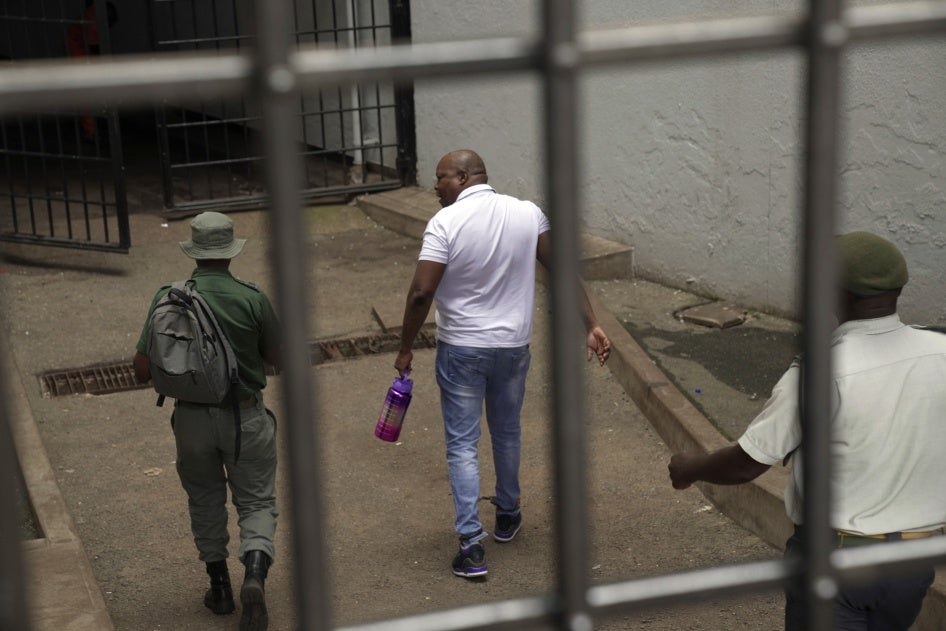 Zimbabwean opposition politician Job Sikhala enters the holding cells at the magistrates court in Harare, Zimbabwe