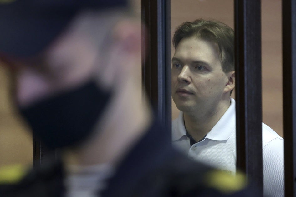 A man is shown behind bars in a courtroom