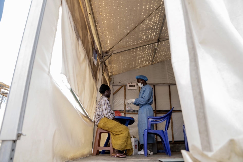 A health worker attends to an mpox patient at a treatment center in Munigi, eastern Democratic Republic of Congo, August 19, 2024. 