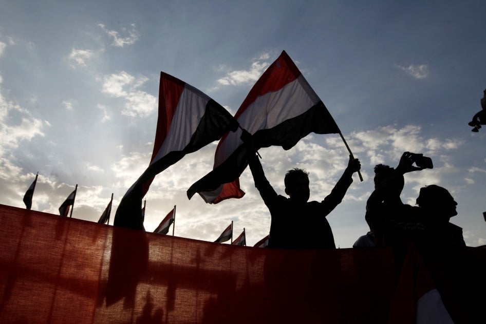 A person waves Yemeni flags during a ceremony marking the anniversary of the September 1962 revolution in Sanaa, Yemen.