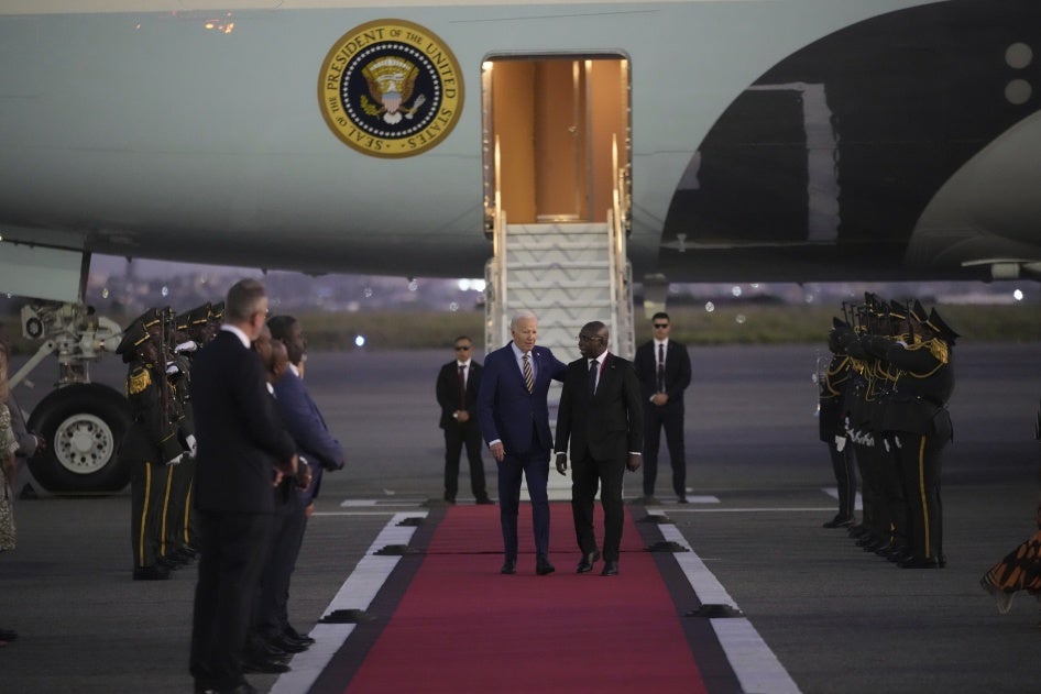 US President Joe Biden is greeted by Angolan Foreign Minister Tete Antonio as he arrives at Quatro de Fevereiro international airport in Luanda, Angola, December 2, 2024.