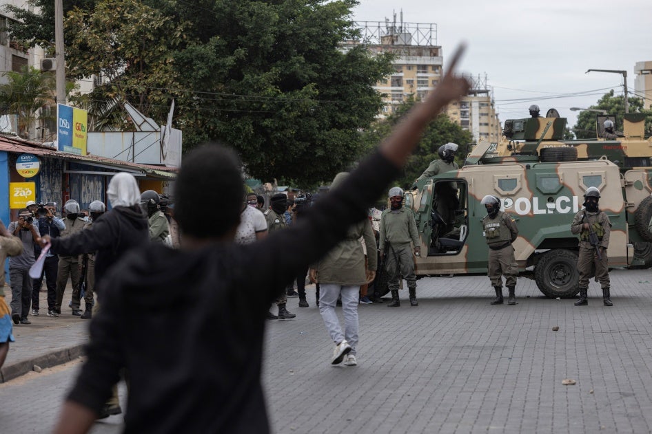 Riot police officers block a road