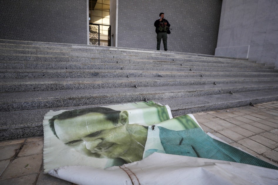 Photo of Bashar al-Assad lies on the floor of the presidential palace in Damascus