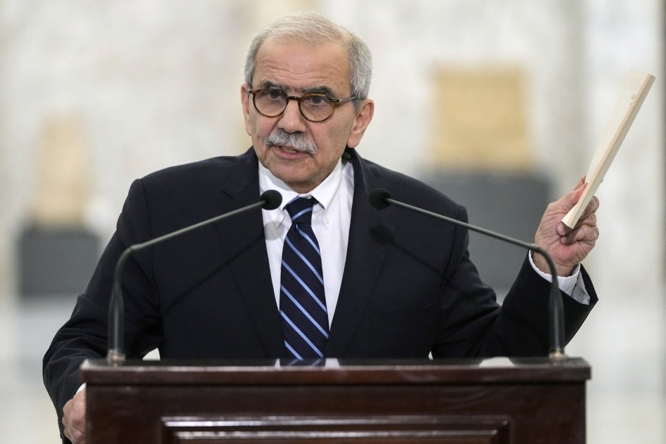 Lebanese Prime Minister-designate Nawaf Salam holds up a copy of the Lebanese Constitution as he speaks at the presidential palace in Baabda, Lebanon, January 14, 2025. 