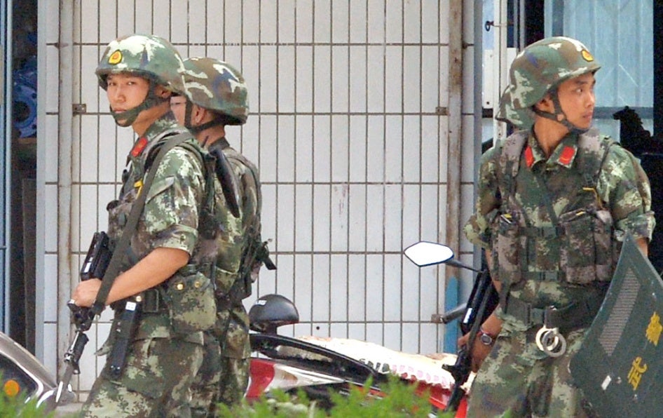Armed Chinese police officers patrol on the street