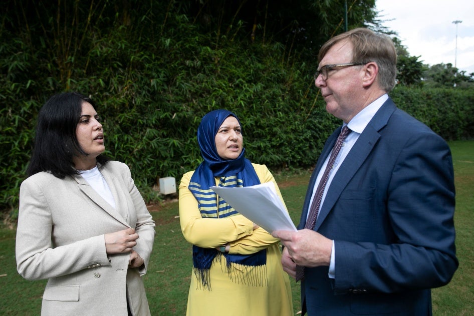 Yusra Ghannouchi (C) and Kaouther Ferjani (L), the daughters of prominent Tunisian detainees, are photographed with their lawyer, British barrister Rodney Dixon.