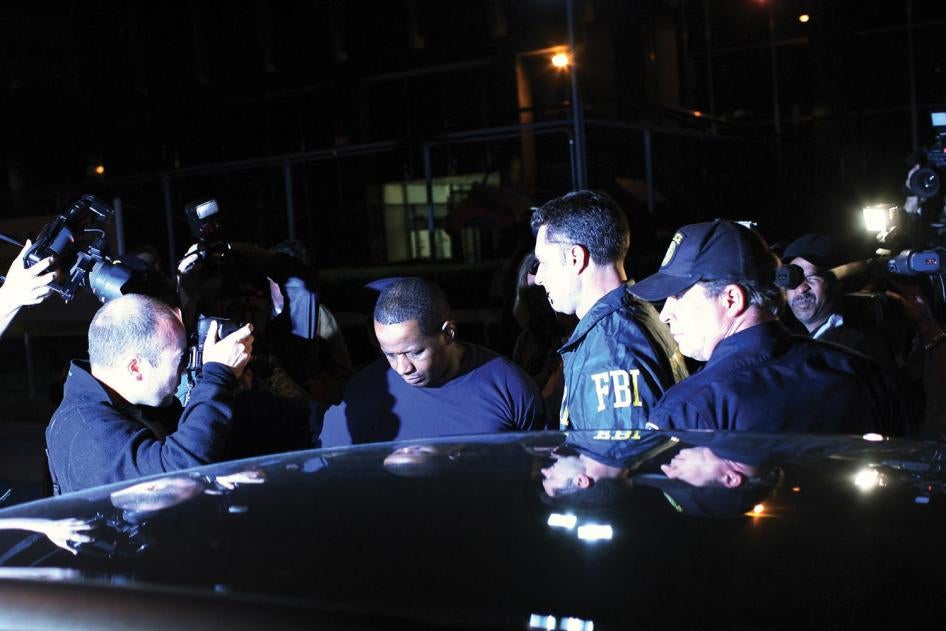 Federal agents and police escort James Cromitie (center) from the FBI’s New York headquarters on May 21, 2009.