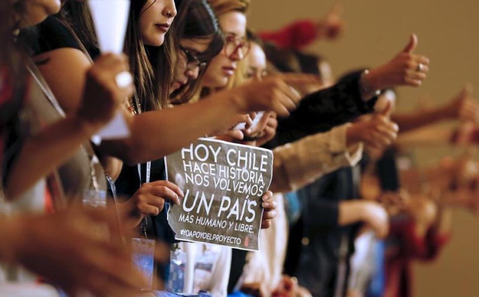 Demonstrators raie their thumbs in approval during a rally inside congress in favor of a draft law by the government, which seeks to ease the country's strict abortion ban, in Valparaiso, Chile March 17, 2016. The banner reads: "Chile makes history today,