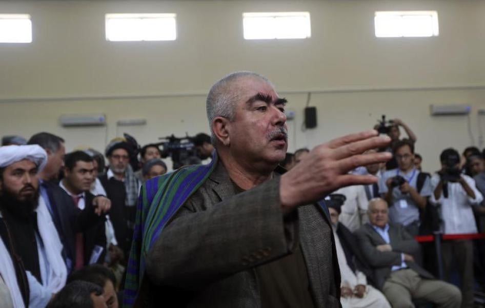 Abdul Rashid Dostum talks with his supporters at the Afghanistan's Independent Election Commission (IEC) in Kabul, Afghanistan, October 6, 2013.
