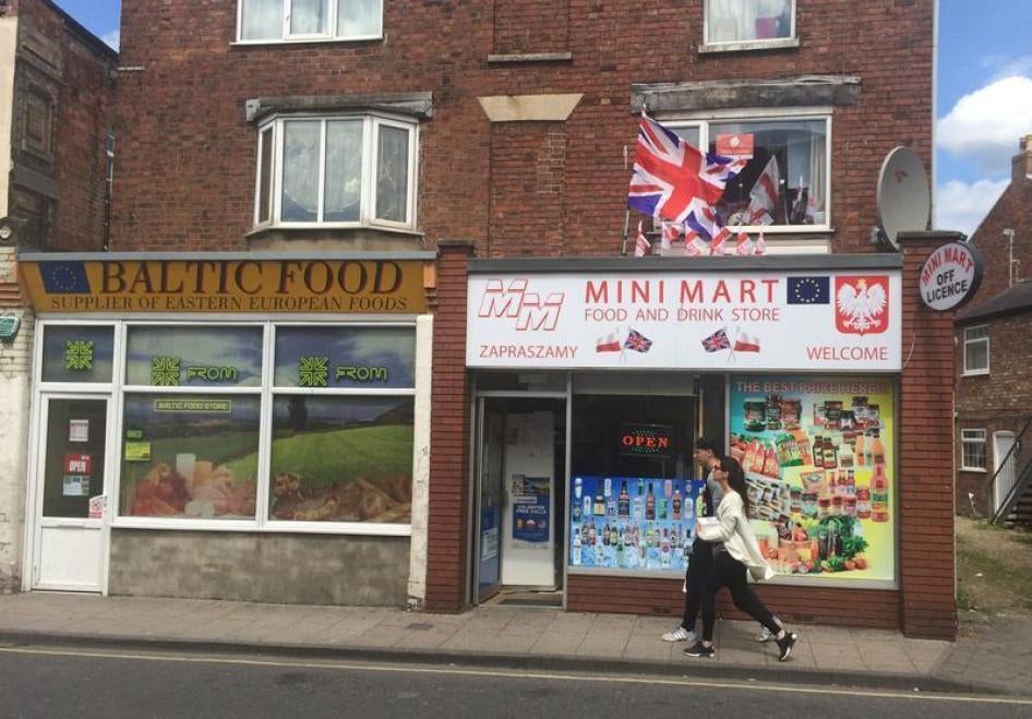 A man and a woman walk past a Polish shop in Boston, Britain June 27, 2016.