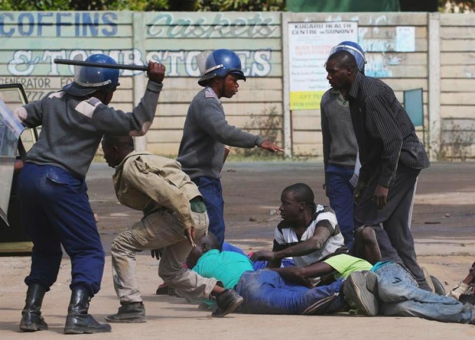 Riot police detain residents of Epworth suburb after a protest by taxi drivers turned violent in Harare, Zimbabwe, July 4, 2016.