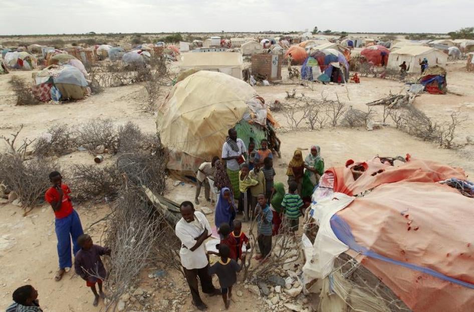 Internally displaced Somalis stand outside a makeshift Muslim Madrasa (Islamic school) at the Halabokhad IDP settlement in Galkayo, northwest of Somalia's capital Mogadishu, July 20, 2011.